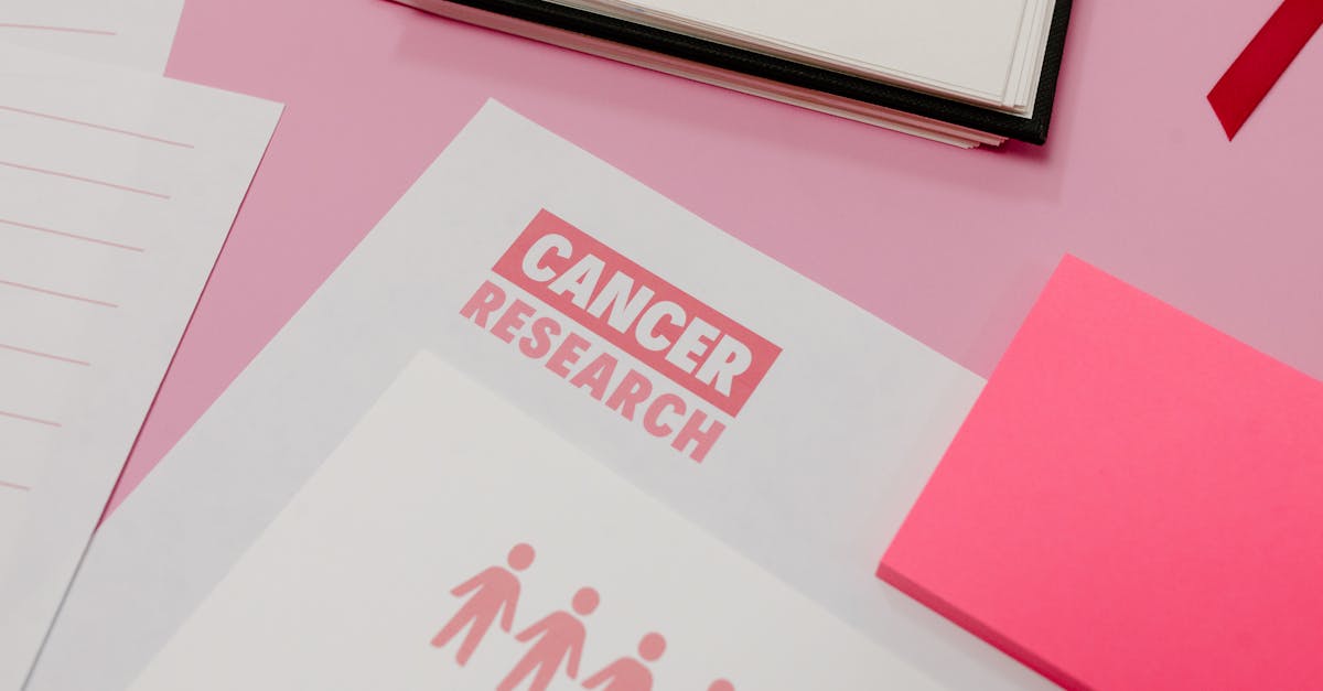 A desk with documents labeled "Cancer Research," symbolizing support and resources available for cancer survivors transitioning back to the workplace.